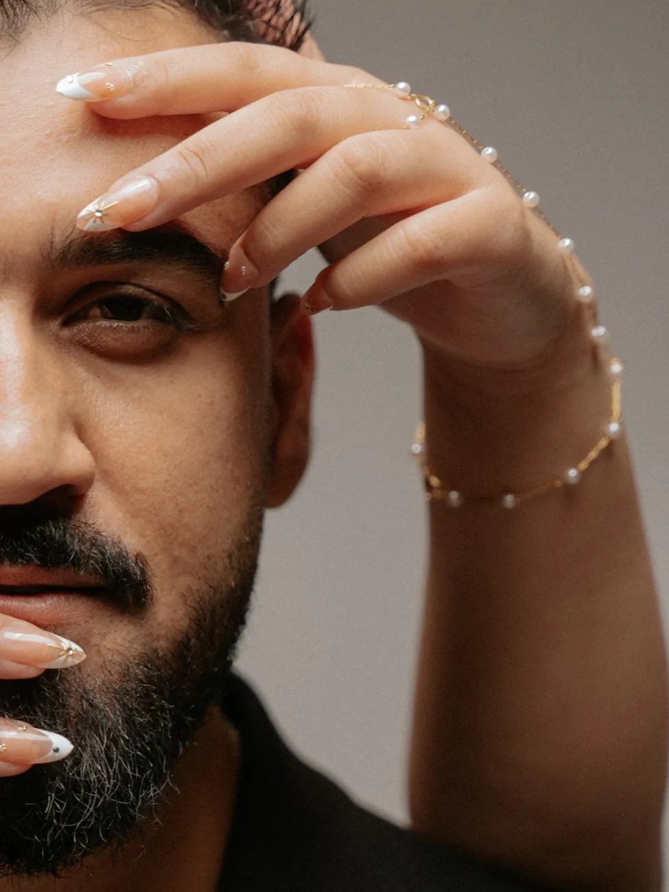 Kashif, with Maha's hand resting on his face