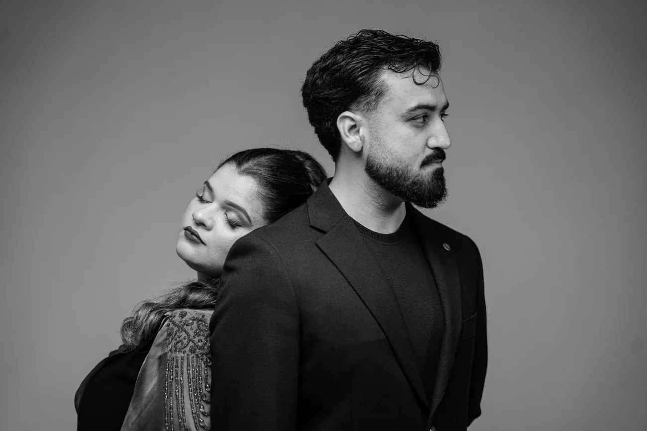 Maha resting her head on Kashif's shoulder